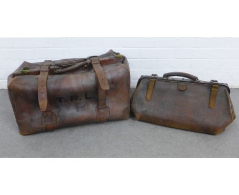 Vintage leather travel bag, with initials T.R.L with brass fittings together with a brown leather Gladstone bag, larger 62 x 