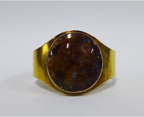 Yellow metal bangle with an inset moss agate style plaque, unmarked,