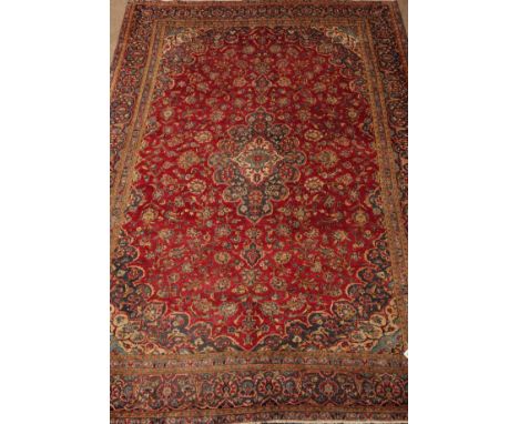 Persian Kashan red ground rug carpet floral field around a central medallion, multiple border, 347cm x 245cm   Condition Repo