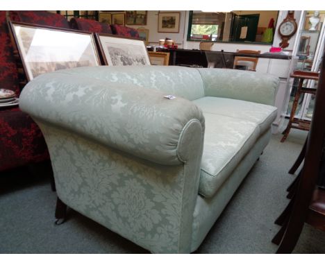 Upholstered Victorian 2 seater green sofa on oak carved square legs on casters