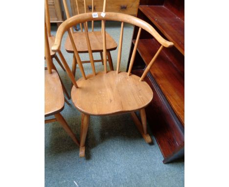 Ercol Light Elm rocking chair with curved stick back and shaped seat 