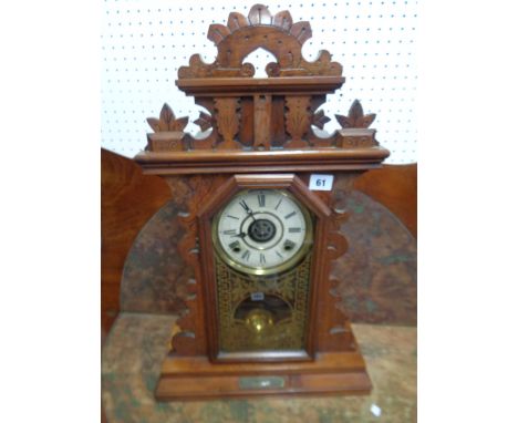 Late 19thC Walnut carved American Mantel clock with glass inset hinged door with gilded detail, Condition - some loss to appl