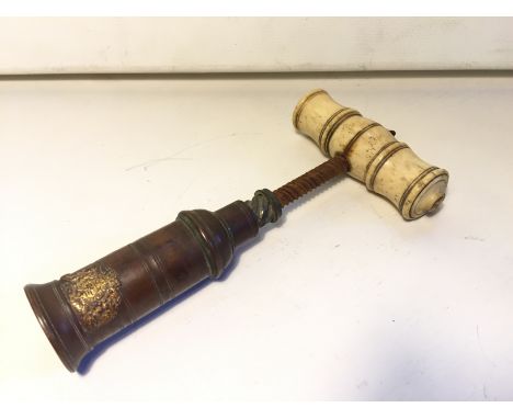 A corkscrew with bone handle and copper body.