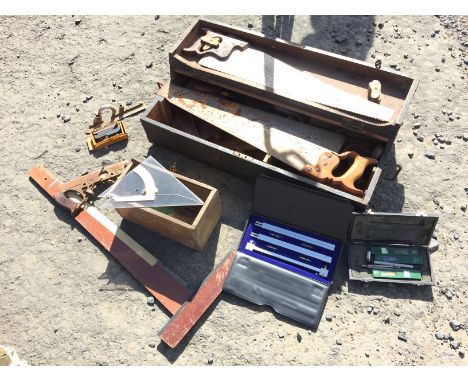 A joiners box containing various hand tools and some drawingg tools.