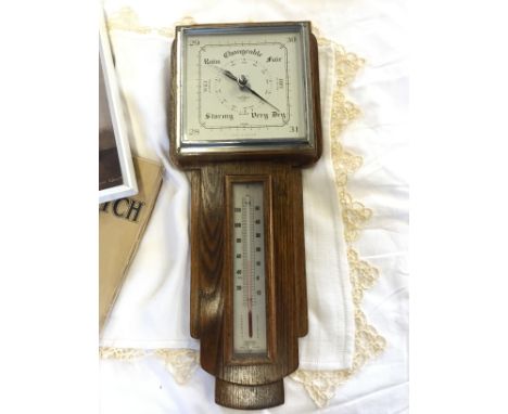 A wall mounted barometer, some music books and a Vernon Ward print