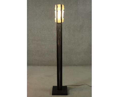 A contemporary steel standard lamp, with an abstract moulded glass shade, on a square base. H.170cm 