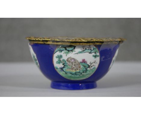 A Chinese hand painted ceramic bowl (used to be a vase) with added gilt ormolu edge. The bowl with a royal blue ground and fo