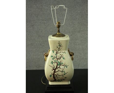 A Chinese style gilded twin handled vase, decorated with fruit blossom design table lamp. H.68cm 