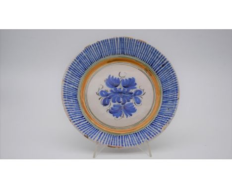An Italian early 20th century glazed ceramic Deruta bowl with blue sunburst border and stylised floral motif to the centre. S