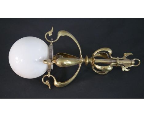 An Art Nouveau brass foliate form ceiling light with white milk glass globe shade. H.48 W.16cm 