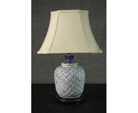 A blue and white Chinese style pineapple design table lamp, mounted on a hardwood base. H.55cm. 