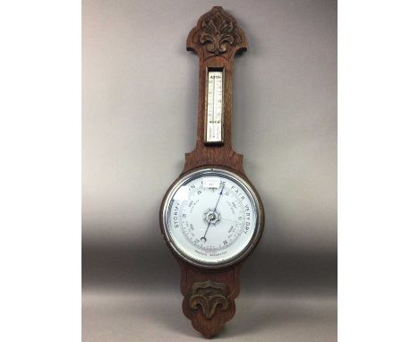 ANEROID BAROMETER WITH THERMOMETER,contained in a carved oak case, 80cm high