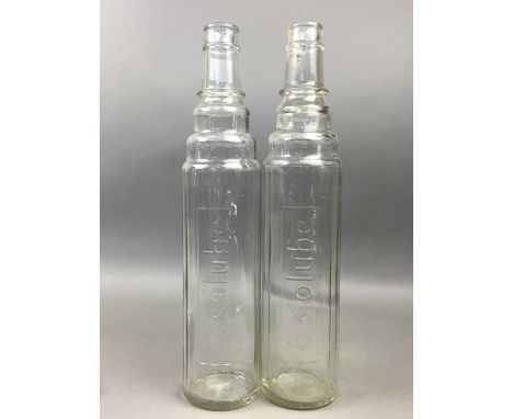 PAIR OF EARLY 20TH CENTURY ESSO LUBE GLASS BOTTLES,each with cylindrical body inscribed 'Essolube', 38cm highThe top of one b