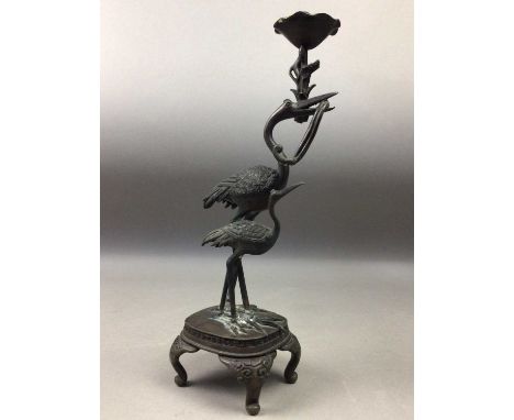 JAPANESE BRONZED SPELTER CANDLESTICK,the column formed as a heron and its young on oblong base to bracket feet, 31cm high, al