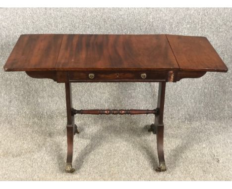 A 19th century mahogany sofa table with drop flap action, of small size. W.112 D.46 H.71cm.