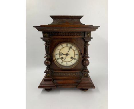 A late 19th century German oak cased mantel clock. H.41cm
