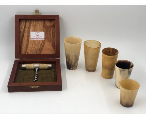 A boxed silver corkscrew marked 900 along with a graduating set of horn beakers. H.10cm.