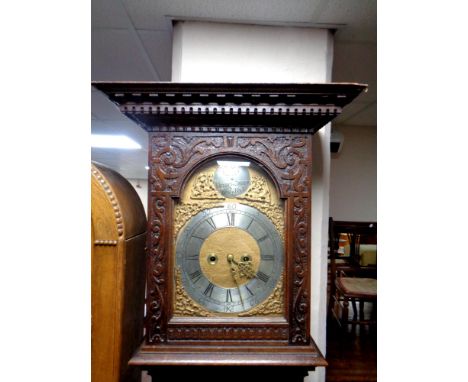 A 19th century heavily carved oak longcase clock with brass and silvered dial by Henrich Dreier, dated 1890, with pendulum 