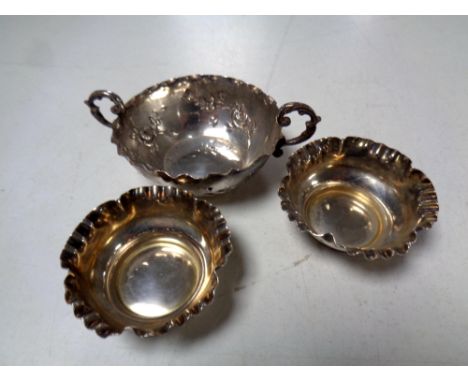 A silver twin-handled wine tasting cup together with a pair of silver salts.  CONDITION REPORT: 53g