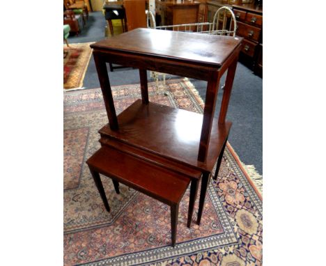 A 20th century nest of three tables and a lamp table 