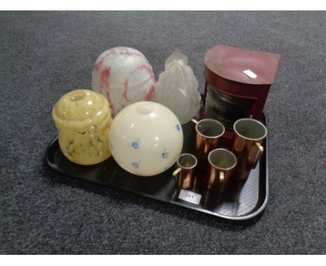 A tray of four early 20th century glass light shades, port ship's lamp, set of four graduated copper brass handled measures. 