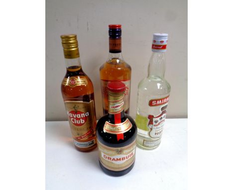 Four bottles of alcohol : The Famous Grouse Scotch whiskey, 1L, Smirnoff Vodka 75cl, Havana Club 70cl and Drambruie 70 cl 