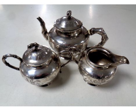 A three piece Chinese silver tea service.  CONDITION REPORT: 789g. Teapot lid with broken hinge. Otherwise good condition. No