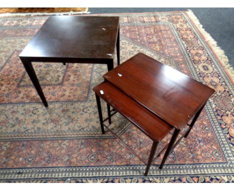 A mid 20th century Danish nest of two tables in a mahogany finish and a lamp table 