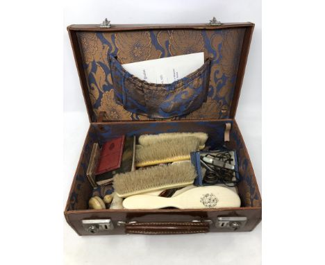 A vintage leather case containing Acme whistle, Girl Guides ephemera, turned ivory darning tools, pocket knife, etc. 