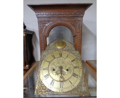 A 19th century carved oak longcase clock hood with movement and brass face, Webster of Whitby  