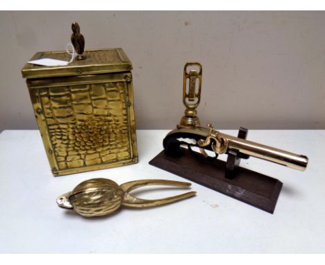 A vintage pistol lighter on stand together with brass tea caddy, unusual brass walnut nut cracker, Coalite bell.