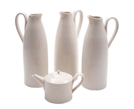 *Hilary Roberts [b.1962] three  porcelain jugs and a teapot: the former of tapering cylinder form with strap handles and pinc