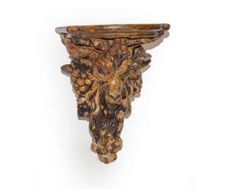 A 19th century Victorian plaster cast wall bracket shaped as a rams head and glazed .  The surfaces have flaked and discolour