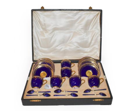 A cased Royal Worcester cobalt blue and gilt highlighted coffee set comprising six cups and saucers and six blue enamelled si