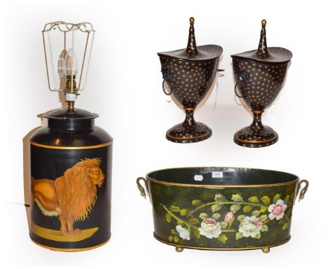 A pair modern toleware lidded urns, each 32cm, together with a reproduction toleware tea canister form table lamp decorated w