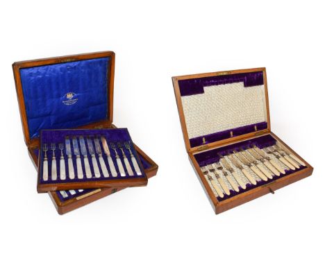 An Edwardian oak cased set of silver and mother of pearl dessert knives and forks by Goldsmiths &amp; Silversmiths Company, L