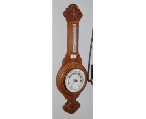 An oak cased aneroid barometer .  Estimate: £30-40