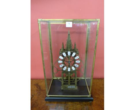 A brass architectural skeleton clock, cased