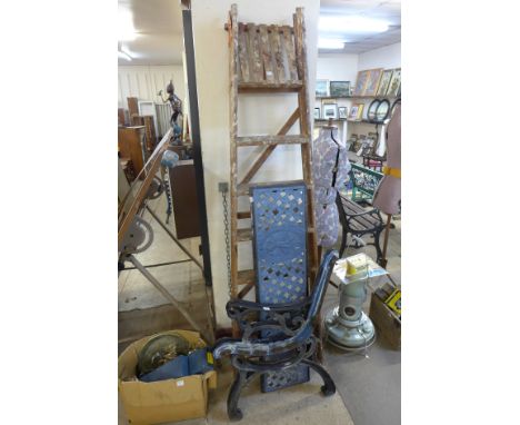 A set of stepladders and pair of cast iron bench ends with back