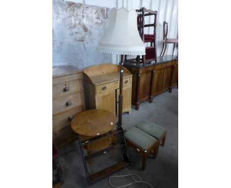 A mahogany standard lamp, a pair of oak stools, a carved oak wall shelf and a circular oak two tier occasional table