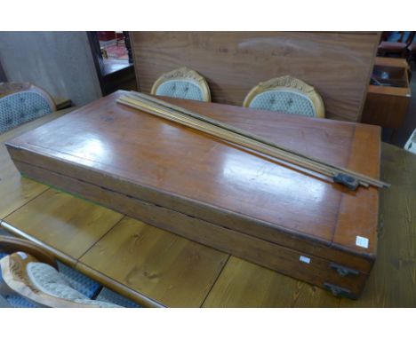 A Victorian mahogany folding bagatelle board and accessories