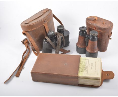 Small leather trunk, width 51cm; pair of field glasses; two pairs of binoculars; and three sets of vintage maps.