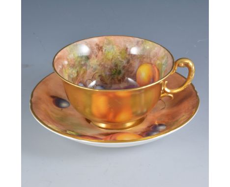 A Royal Worcester cup and saucer, painted number W9535, painted with fruit by John Cook, signed, saucer diameter 14.5cm, (2).