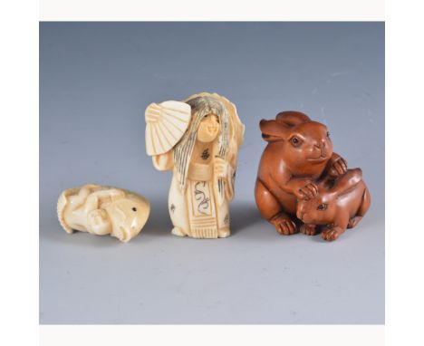 A Japanese carved ivory netsuke, a boy and a fish, character mark, Meiji, 32mm, another Japanese carved ivory netsuke, figure