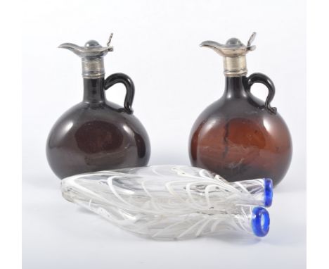 Nailsea type double flask, light festooned decoration, 25cm and two brown glass claret jugs with white metal mounts, (3).