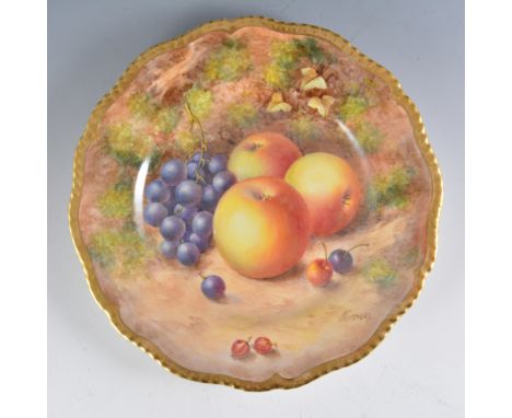 A Royal Worcester plate, wavy rim, painted with fruit by John Freeman, signed, diameter 23.5cm.
