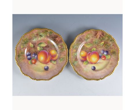 A pair of Royal Worcester plates, shaped rims, painted numbers 312 and C55, painted with fruit by John Cook, signed, diameter