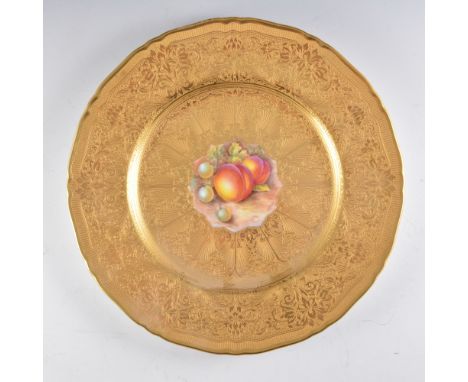 A Royal Worcester cabinet plate, tooled gilt border, the centre panel painted with fruit by John Cook, signed, diameter 27cm.