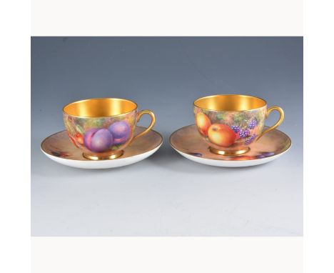 A Royal Worcester cup and saucer, painted number W9535, painted with fruit by John Freeman, signed, saucer diameter 14.5cm, a