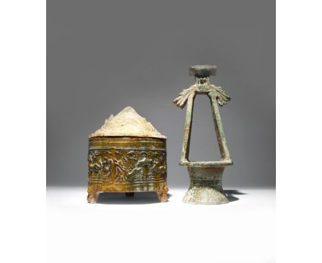 A CHINESE POTTERY 'HILL' JAR AND COVER AND A MODEL OF A WELL HEAD HAN DYNASTY The jar moulded with various animals including 